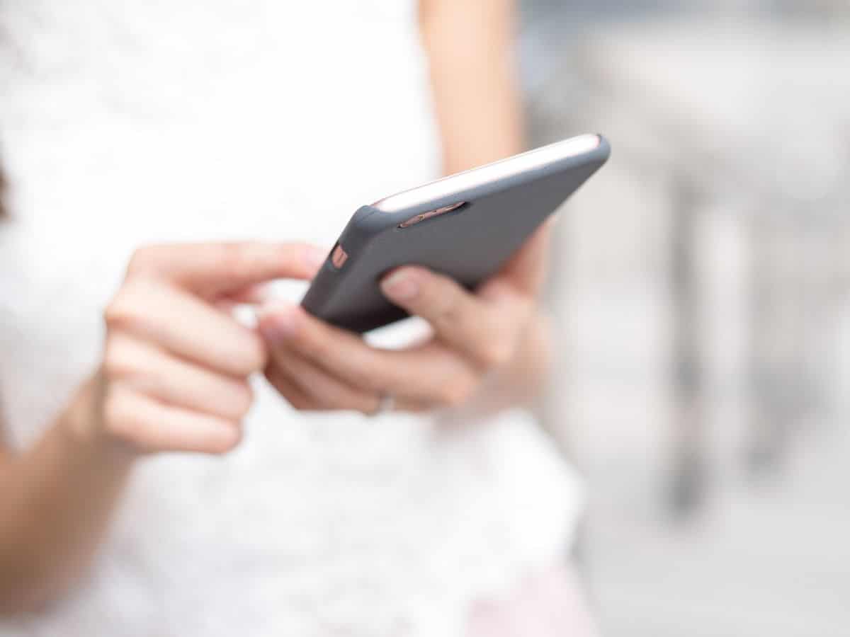Woman looking at app on cell phone