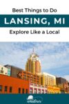 A cityscape of Lansing, MI with colorful buildings under a partly cloudy sky. Text reads "Best Things to Do: Lansing, MI. Explore Like a Local." Everyday Wanderer logo at the bottom.