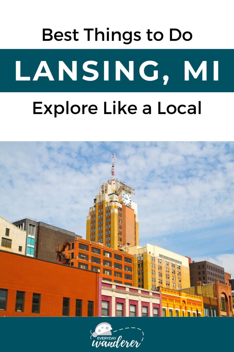 A cityscape of Lansing, MI with colorful buildings under a partly cloudy sky. Text reads "Best Things to Do: Lansing, MI. Explore Like a Local." Everyday Wanderer logo at the bottom.