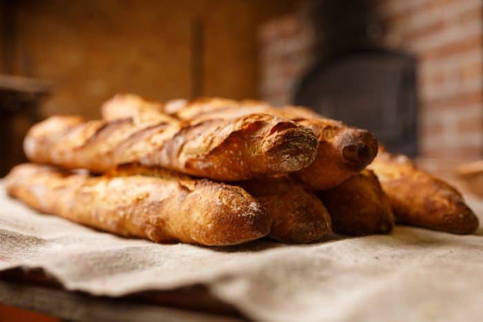 A stack of French baguettes fresh from the oven