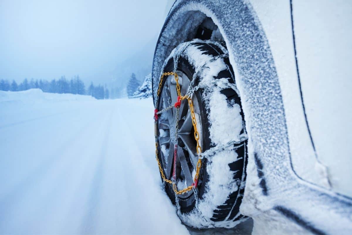 Car Driving with Snow Chains in Wintry Weather