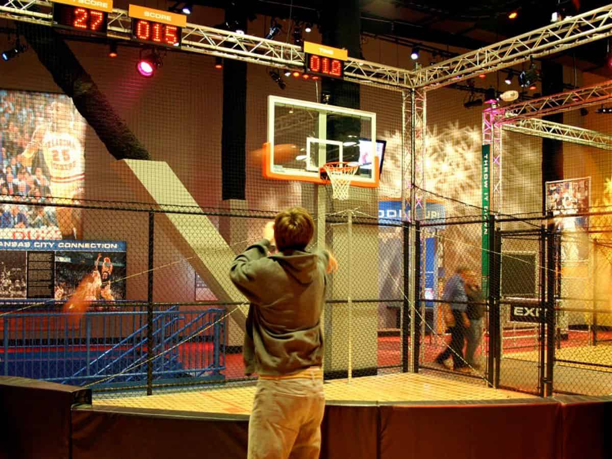 A man standing in front of a basketball hoop at Loews Kansas City Hotel.
