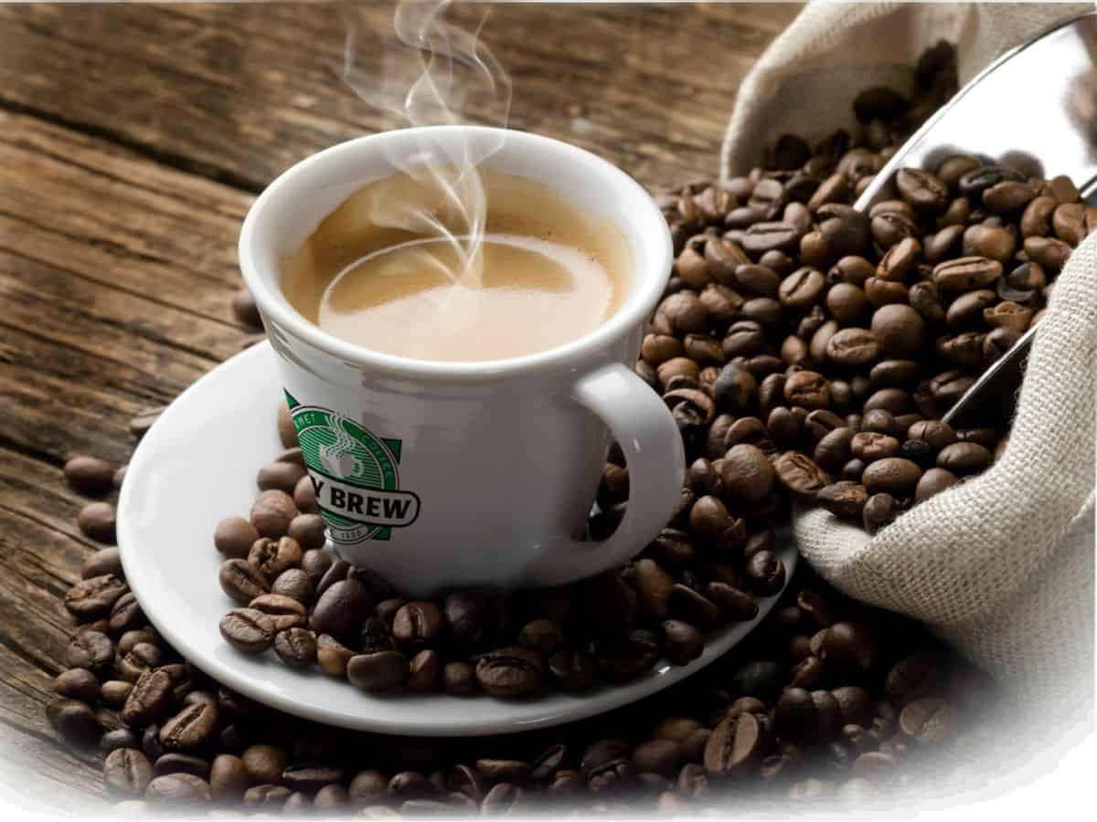 Cup of steaming coffee in a City Brew cup