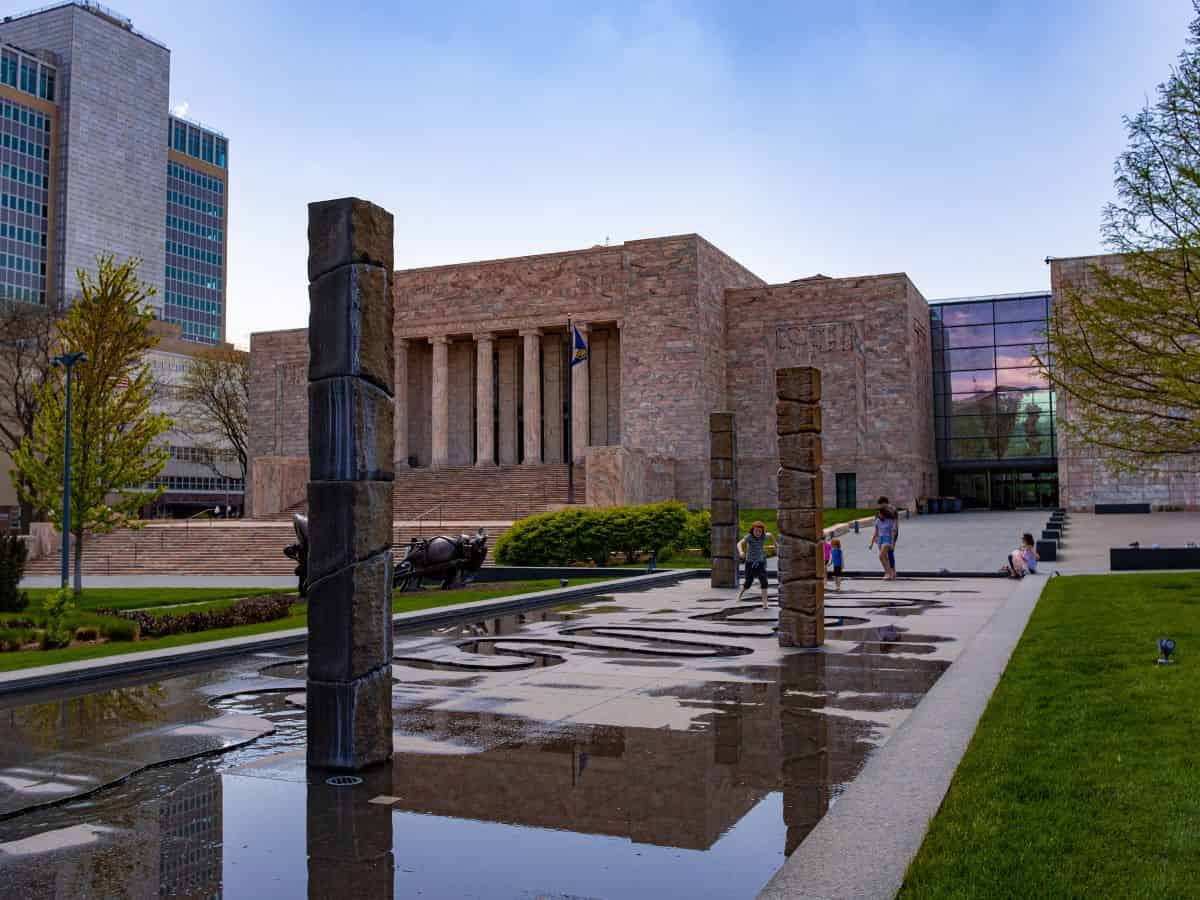 Kids play in a water fountain outside the Joslyn Art Museum in Omaha, NE.