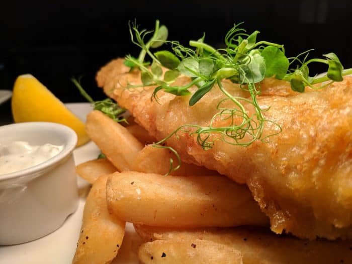 Fried fish is usually accompanied by potatoes, cabbage, and bread at Friday fish fries in Wisconsin.
