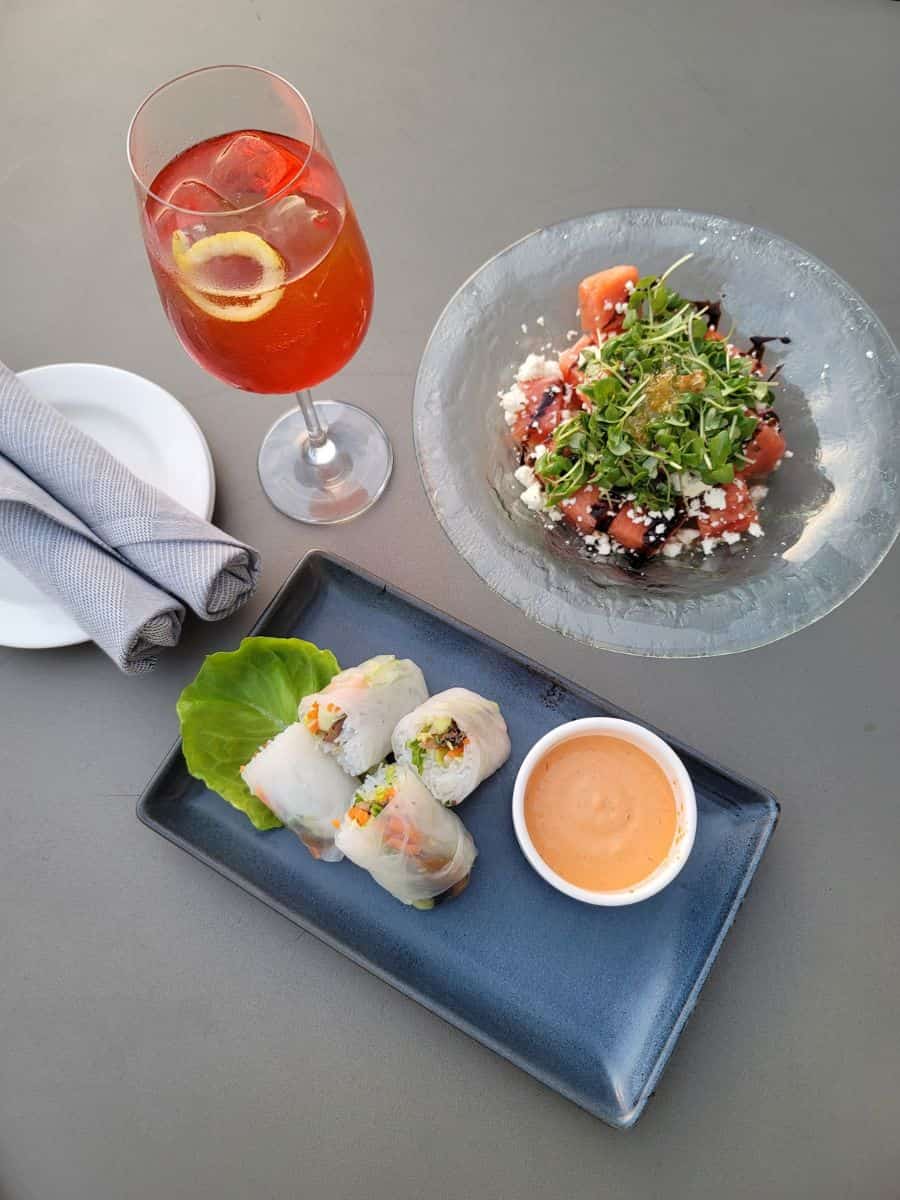 A plate of food and a drink on a table at Horsefeather Social.