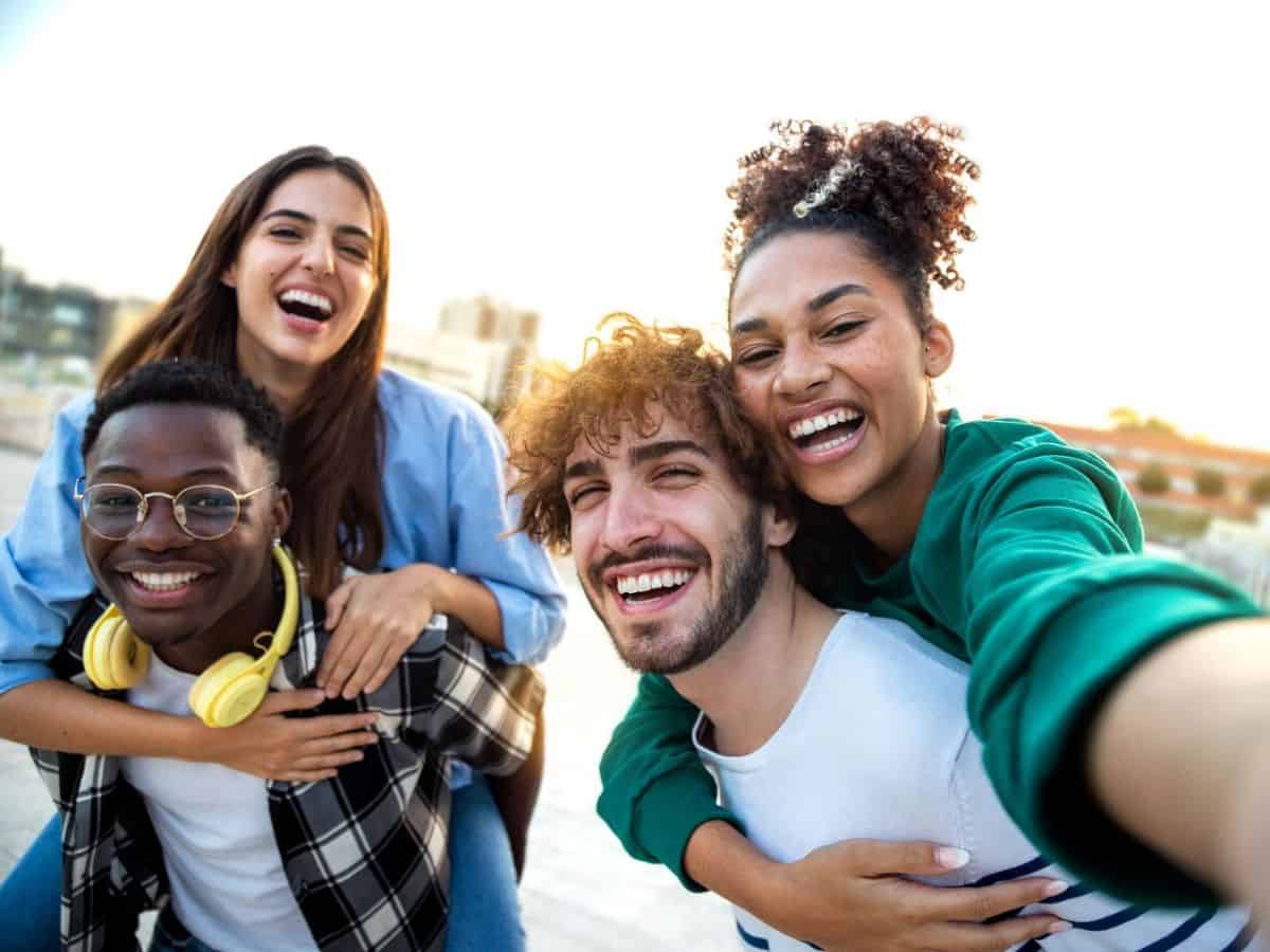 A group of friends on a scavenger hunt taking a selfie.