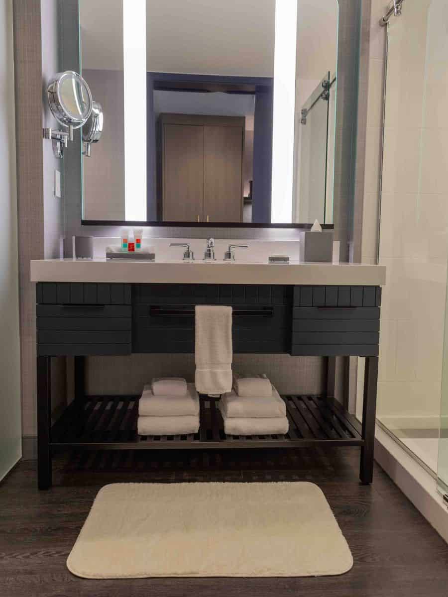 Loews Kansas City Hotel bathroom with sink and mirror.