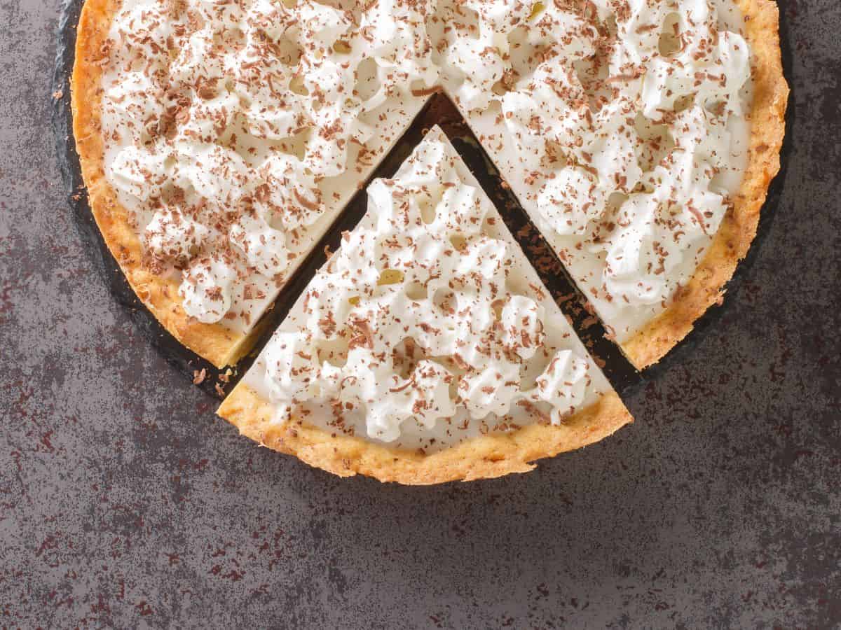 A haupia pie with one slice cut.