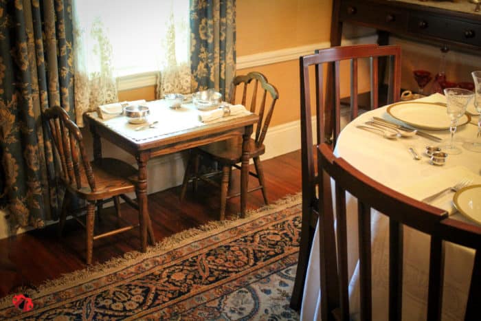 A small table for two of the Kennedy children next to the window in a dining room.
