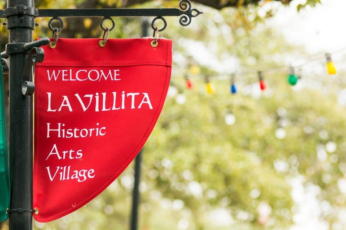 A red sign welcoming visitors to La Villita in San Antonio