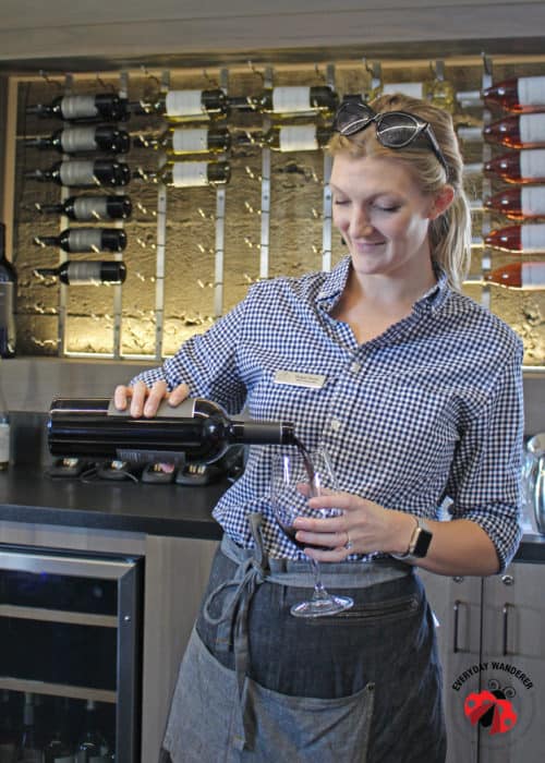 A woman pouring wine at a Livermore wine tasting.