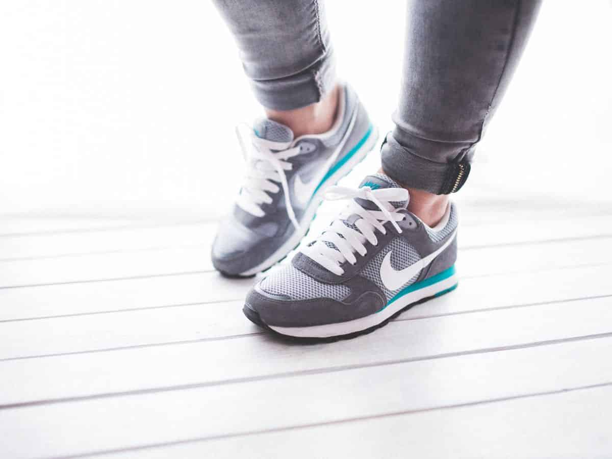 A woman wearing Nike tennis shoes and comfortable pants