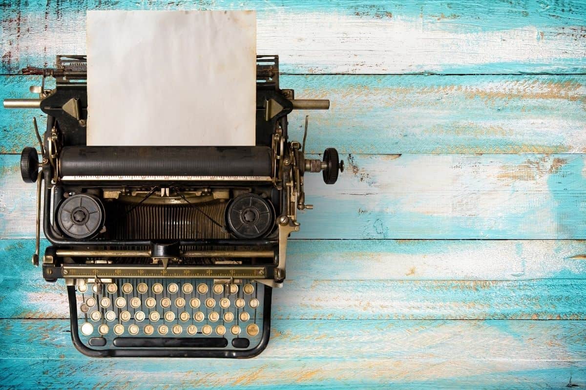 An old typewriter on a blue wooden background.