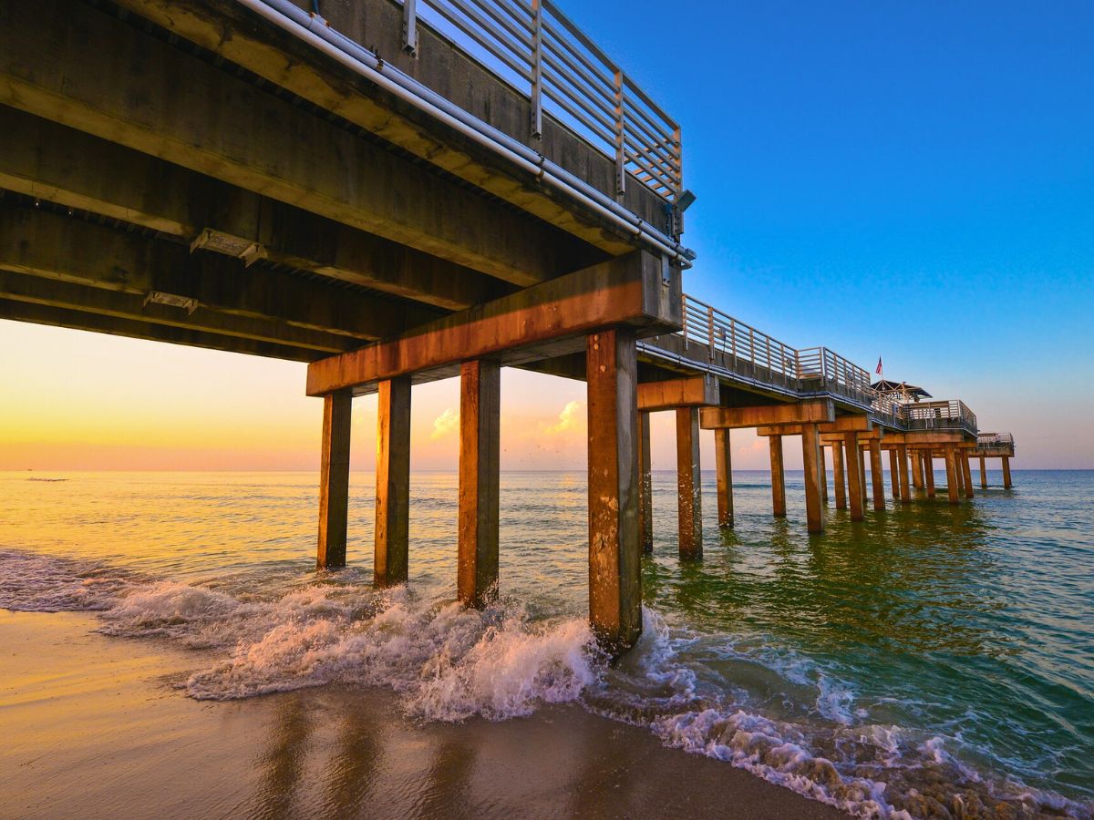 A pier jutting out into the Gulf of Mexico at sunset.