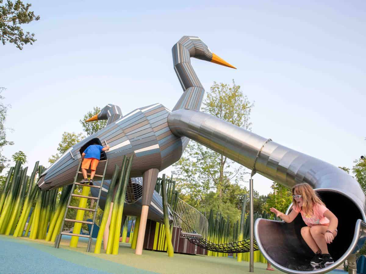 Kids playing at a playground at The Gathering Place.