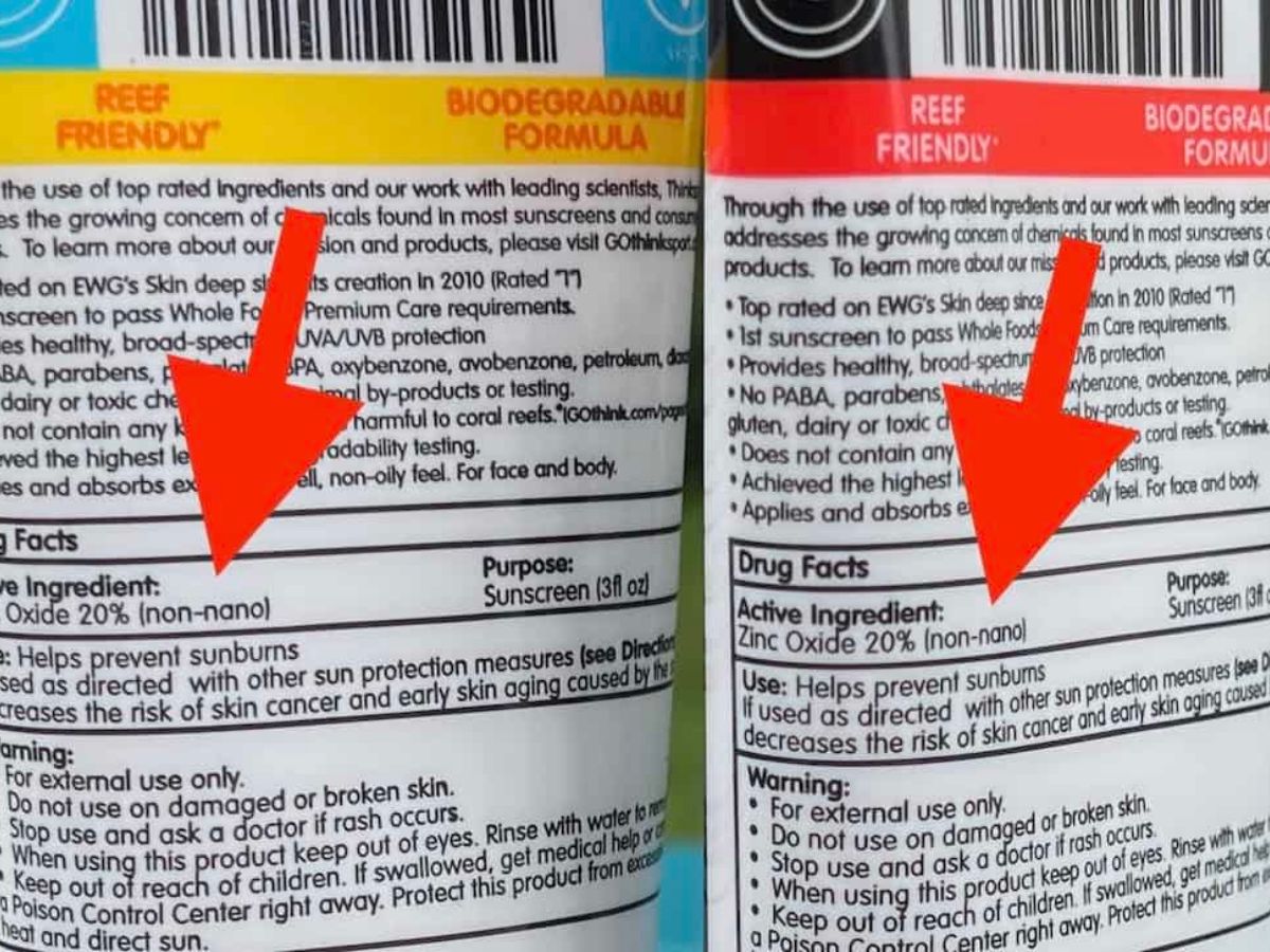Close-up of two sunscreen labels showing the active ingredient Zinc Oxide 20% (non-nano) with arrows pointing to the ingredient list and "Reef Friendly" labeling at the top of both bottles.