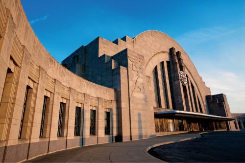 The exterior of a large building with windows and a blue sky in Cincinnati.