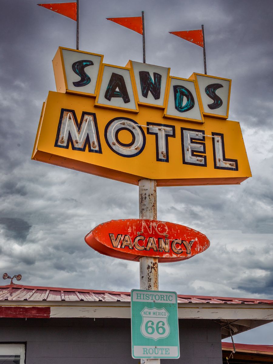 Vintage Sands Motel sign with "No Vacancy" displayed; located on Historic Route 66 under a cloudy sky.