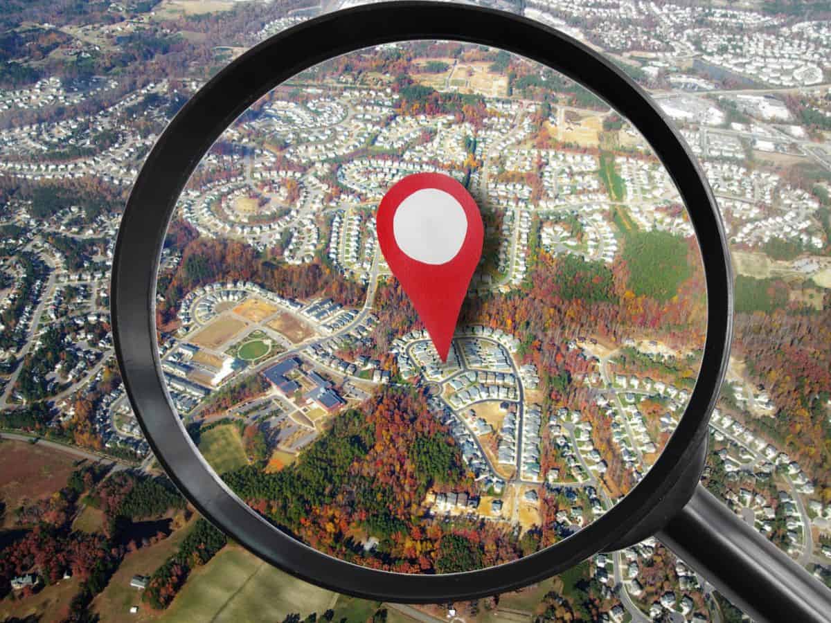 A scavenger hunt tool combining a magnifying glass with a GPS pin.