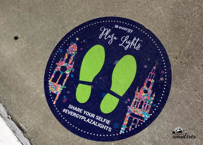 A sticker on the ground directing visitors to great views of the Country Club Plaza Lights.