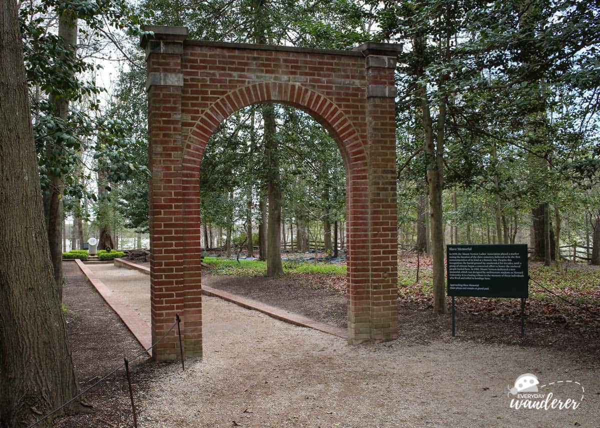 A red brick arch that serves as the entrance to the slave cemetery and memorial at Mount Vernon.