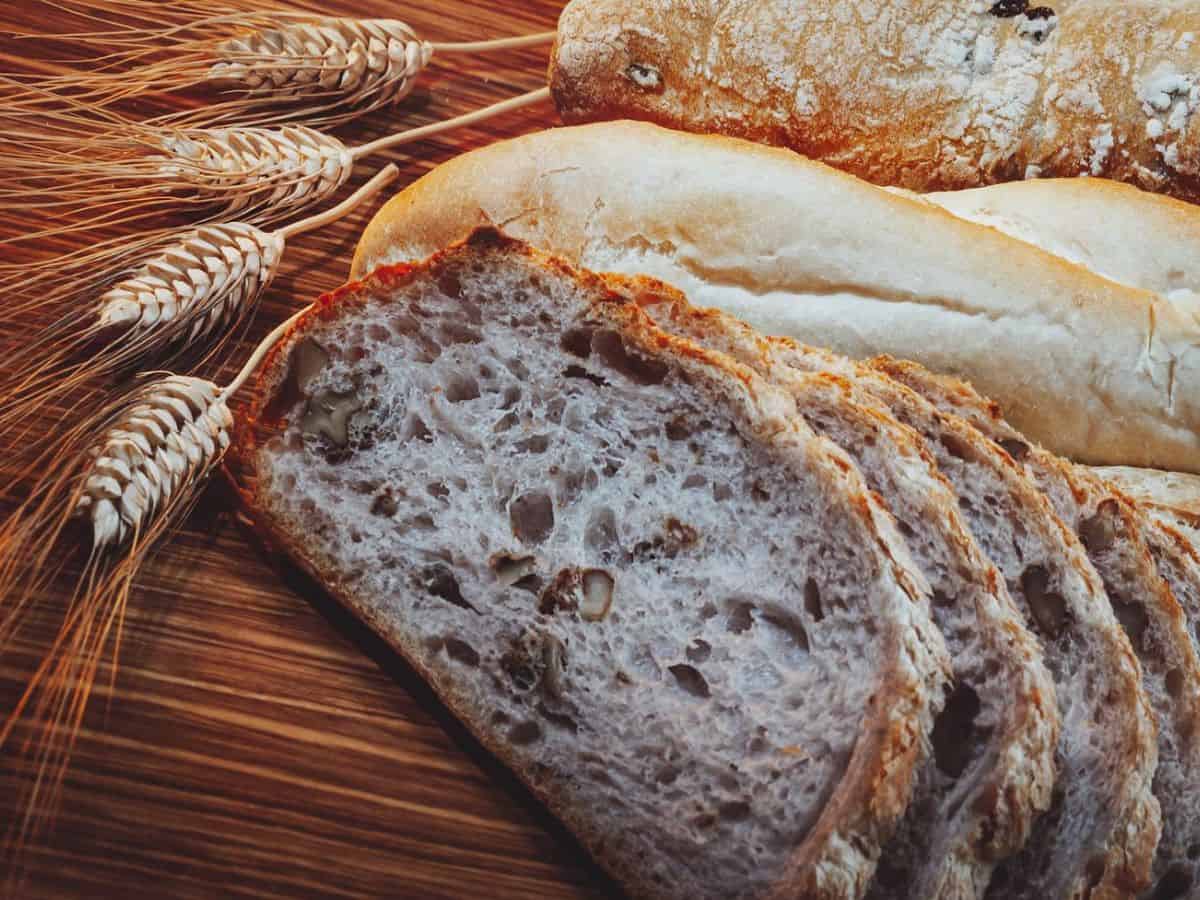 Bread and wheat on a wooden table.