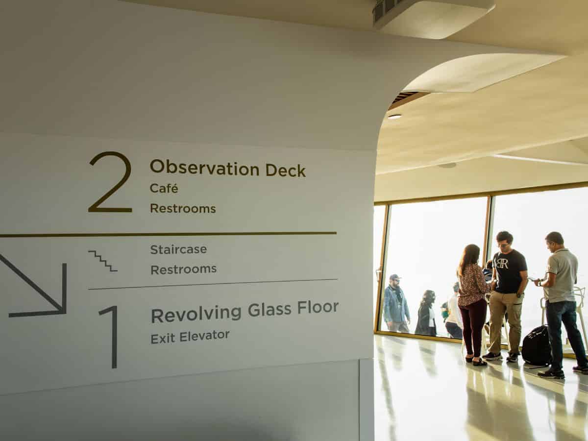 A group of people visiting the Space Needle observation deck.