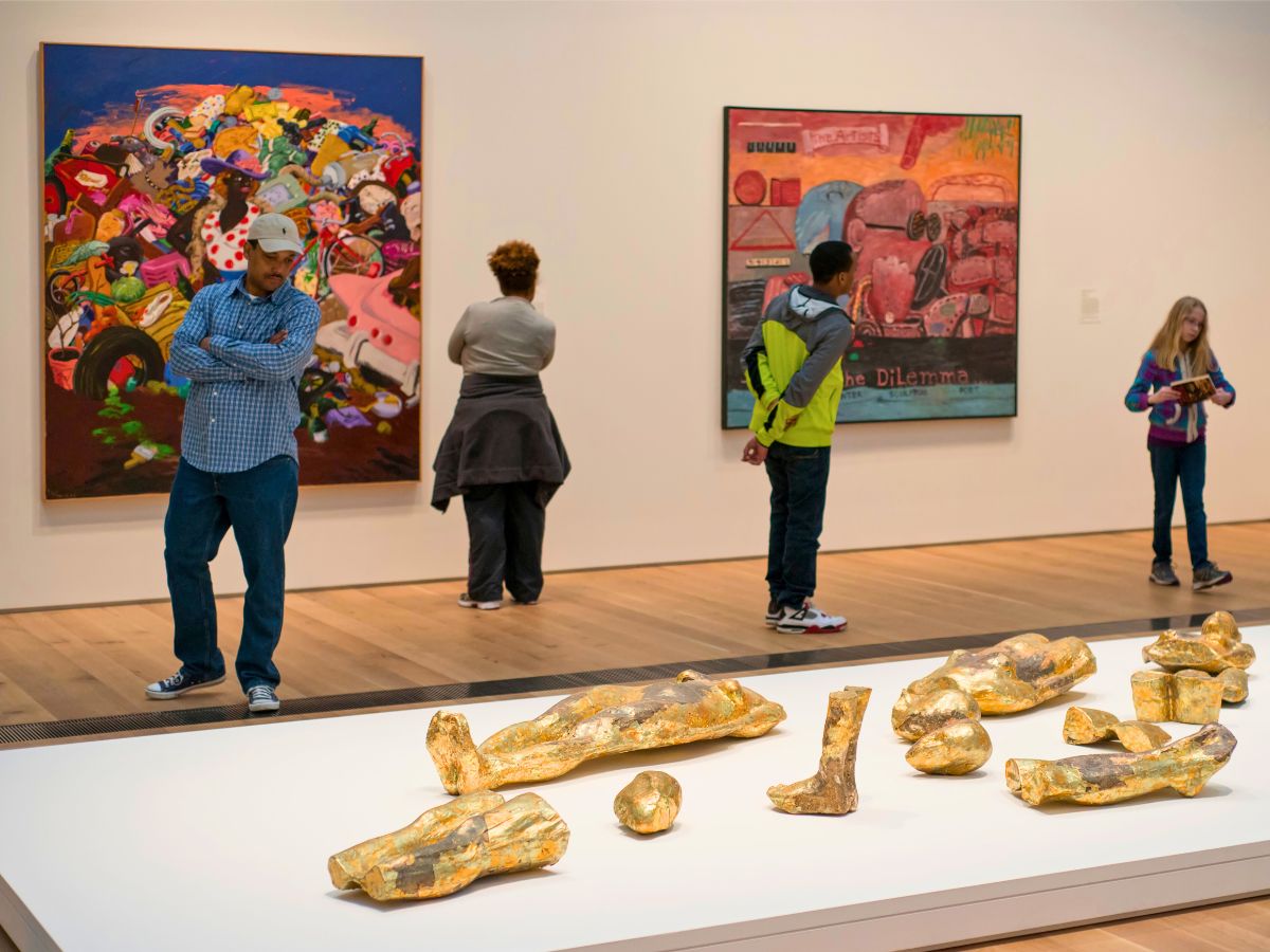 Visitors observing art at the St. Louis Art Museum.