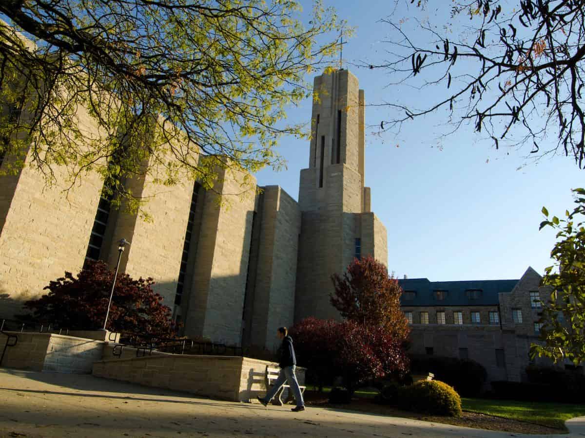 A person walking in front of St. Benedict's Abbey in Atchison Kansas.