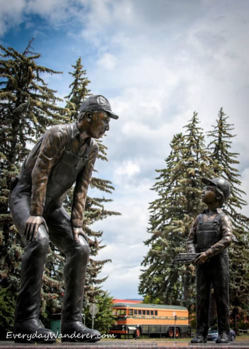 Statue of train conductor and boy by train
