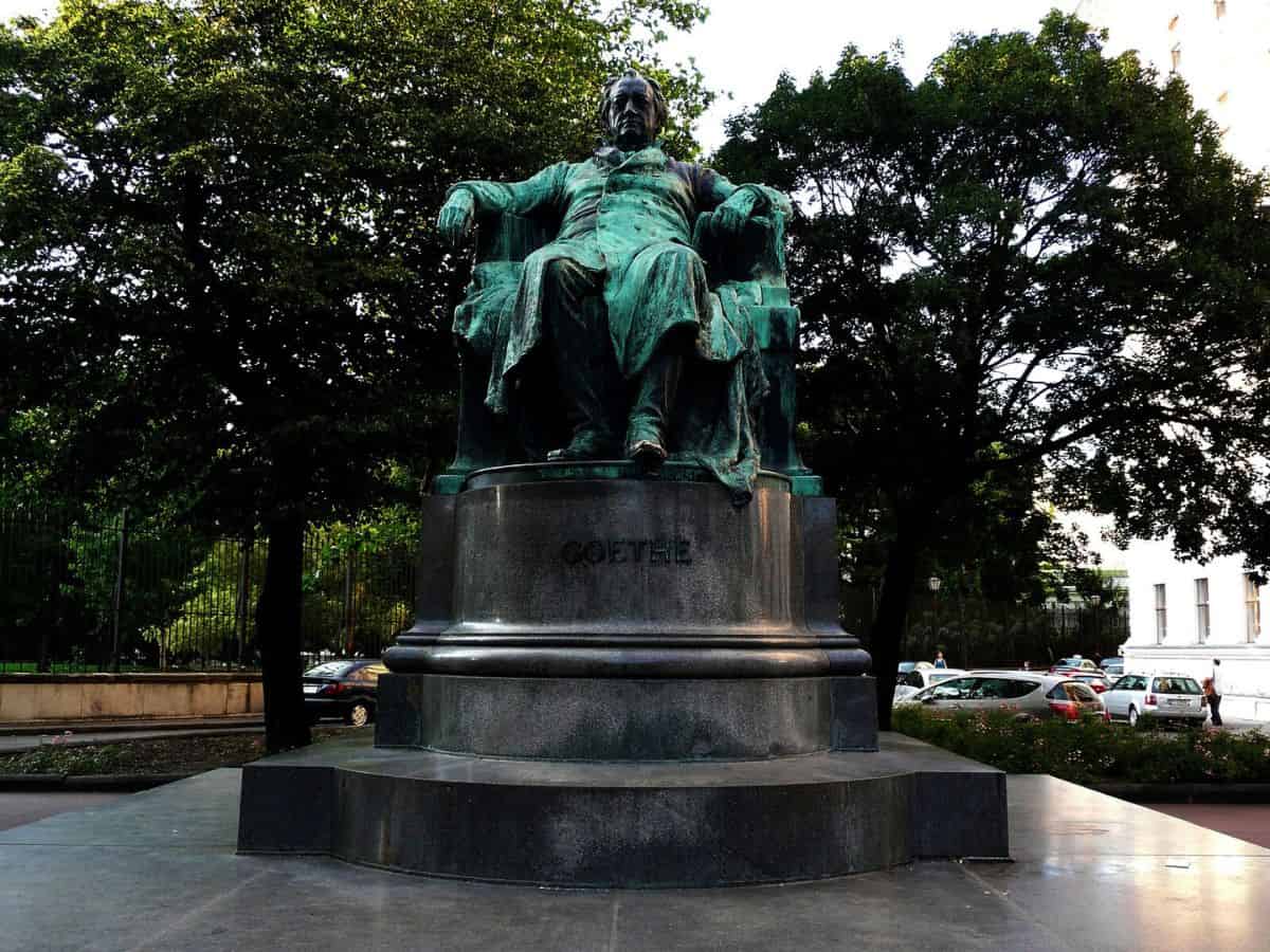 A statue of Goethe sitting in a chair.