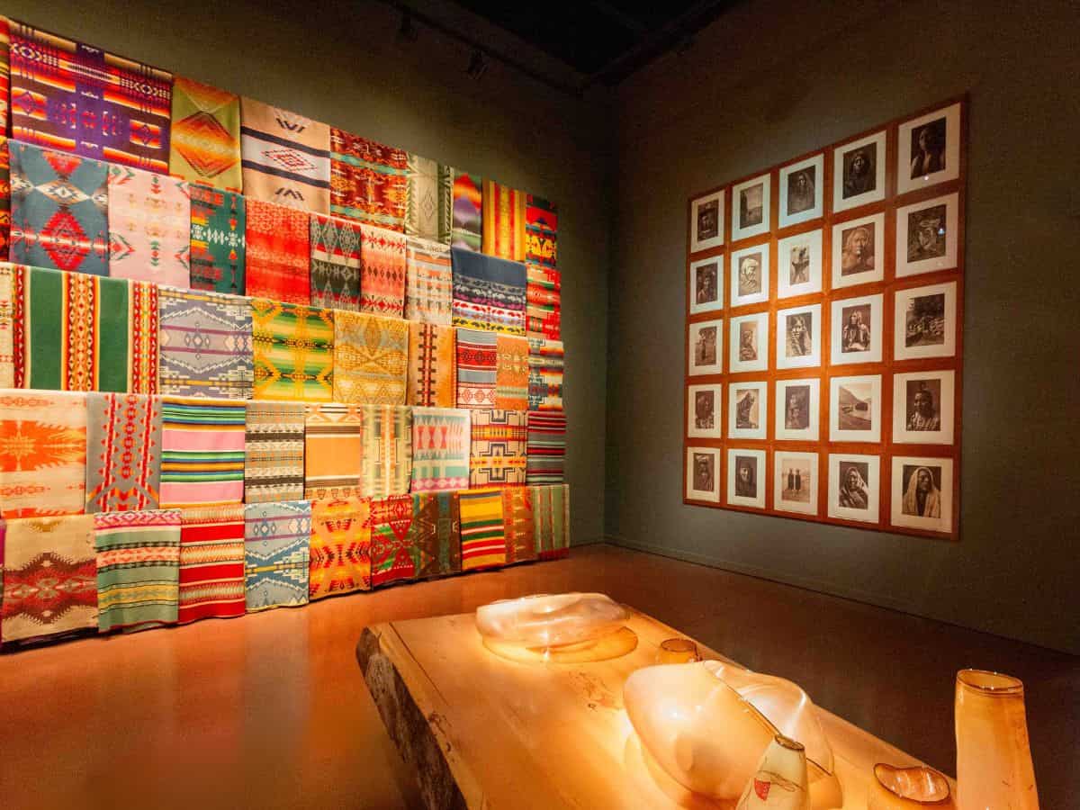 Colorful tapestries hanging on the wall at a Chihuly exhibit in Seattle.