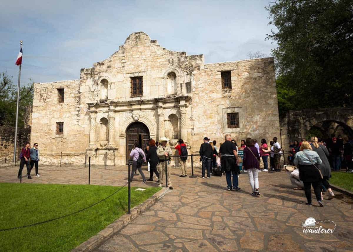 Visitors walk toward the entrance of the Alamo
