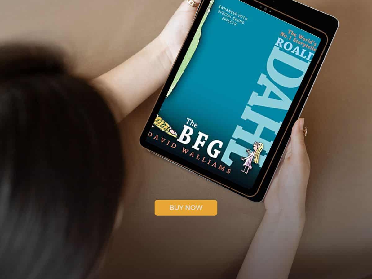 A woman is using an iPad to listen to audiobooks for family road trips.