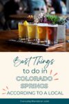 Four beers on a wooden tray with a plant and people in the background. Text below reads "Best Things to do in Colorado Springs According to a Local.