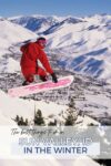 Snowboarder in red outfit jumping off a snowy slope, overlooking a town nestled in snow-covered mountains, with text reading "The best things to do in Sun Valley, ID in the winter.
