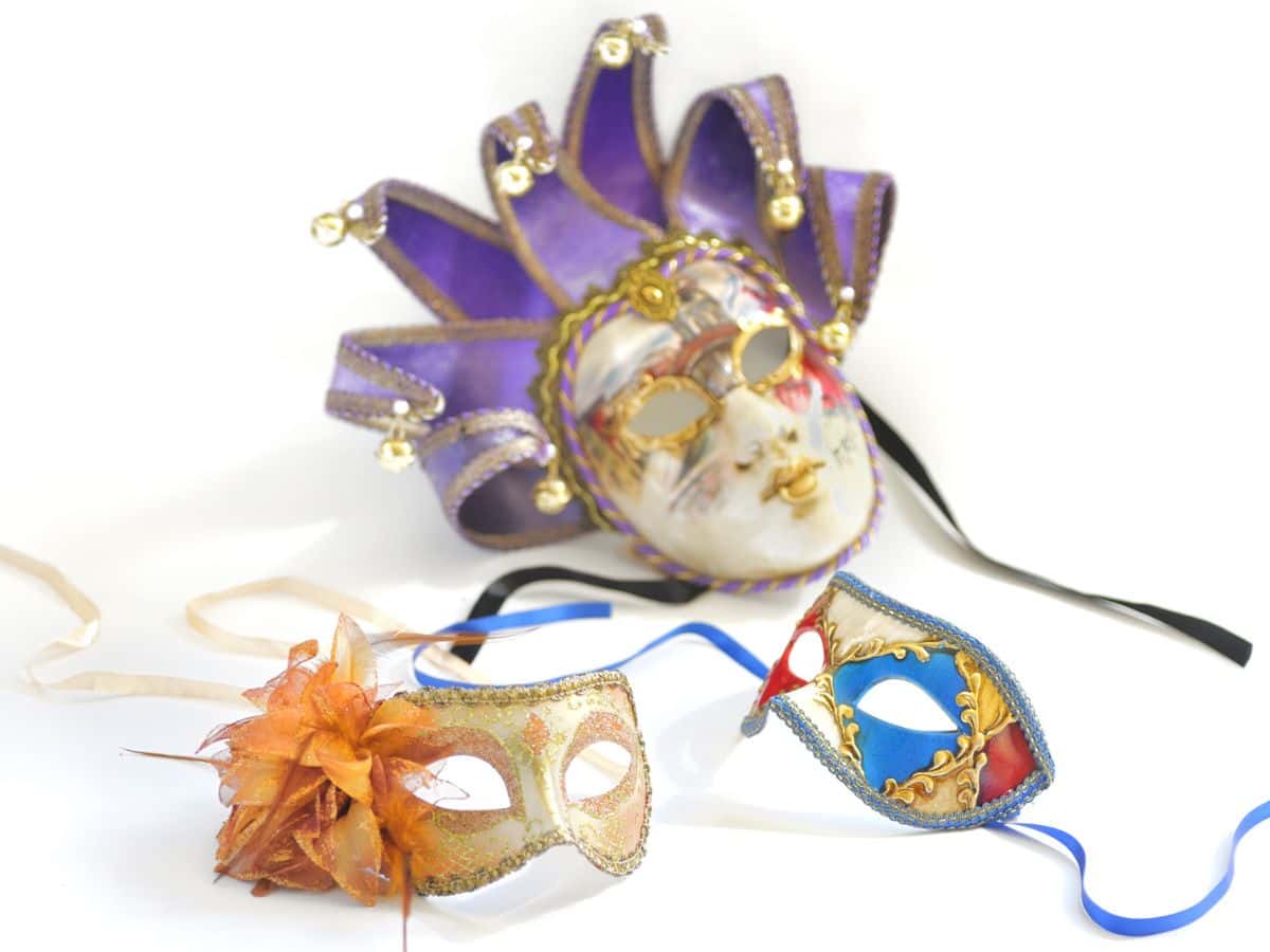 Three different Mardi Gras masks on a white background.