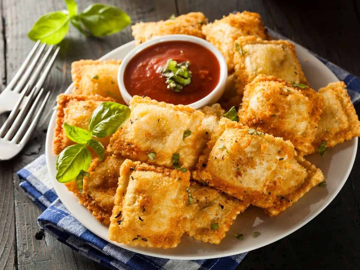 A plate of toasted ravioli with marinara sauce