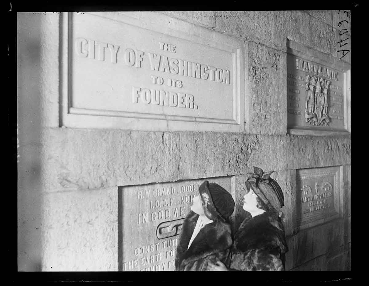 Two women standing in front of the iconic Washington Monument in Washington, D.C.