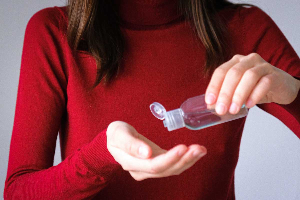Woman Applying Hand Sanitizer