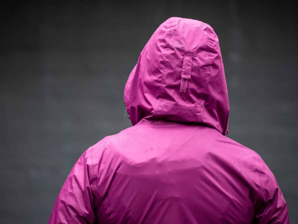 A woman in a purple rain jacket.