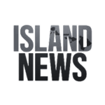 A logo with the text "Island News" in bold, uppercase letters, with a small depiction of an island within the letters. The design is in grayscale tones.