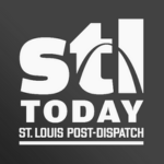 STL Today logo featuring the Gateway Arch, accompanied by the text "St. Louis Post-Dispatch" below it. The background is dark grey.